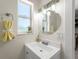 Bathroom featuring a clean vanity and ample natural light from a window, creating a serene space at 6780 Greenbrier Dr, Seminole, FL 33777