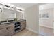 Well-lit bathroom with a modern double sink vanity and a view to the next room at 6780 Greenbrier Dr, Seminole, FL 33777