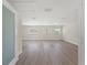 Bright bedroom with three windows, light-colored flooring, and base molding at 6780 Greenbrier Dr, Seminole, FL 33777