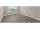 Bedroom featuring a window view and light wood-style flooring, creating a serene atmosphere at 6780 Greenbrier Dr, Seminole, FL 33777