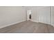 Bright bedroom featuring updated flooring and a closet, next to a laundry room at 6780 Greenbrier Dr, Seminole, FL 33777