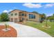 Charming two-story home with a balcony, two-car garage, and a meticulously maintained front yard at 6780 Greenbrier Dr, Seminole, FL 33777