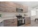 Charming kitchen features stainless steel appliances, light countertops, and light wood cabinets at 6780 Greenbrier Dr, Seminole, FL 33777