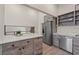 Kitchen features stainless steel appliances, bright countertops and views of the upstairs loft at 6780 Greenbrier Dr, Seminole, FL 33777