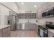 Modern kitchen featuring stainless steel appliances, light countertops and an open design at 6780 Greenbrier Dr, Seminole, FL 33777