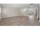 Spacious living room featuring sleek flooring, recessed lighting, and access to upstairs area at 6780 Greenbrier Dr, Seminole, FL 33777