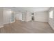Bright living room with modern flooring, white trim, and access to other rooms at 6780 Greenbrier Dr, Seminole, FL 33777