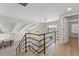 Open loft area features bright lighting, and easy access to the stairs and living room at 6780 Greenbrier Dr, Seminole, FL 33777