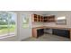 Home office featuring custom cabinets, a view to the yard, and an individual AC unit at 6780 Greenbrier Dr, Seminole, FL 33777