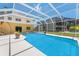 View of the enclosed swimming pool and spa from the home's patio at 6780 Greenbrier Dr, Seminole, FL 33777