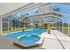 Enclosed swimming pool and spa with views of the lawn and blue skies at 6780 Greenbrier Dr, Seminole, FL 33777