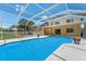 View of the backyard featuring an enclosed swimming pool and spa at 6780 Greenbrier Dr, Seminole, FL 33777