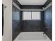 Elegant shower featuring dark tile and a decorative border, offering a luxurious bathing experience at 6780 Greenbrier Dr, Seminole, FL 33777