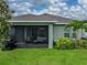 View of the backyard featuring a screened-in lanai with comfortable seating, perfect for outdoor relaxation at 8119 Trimbelle Ter, Parrish, FL 34219