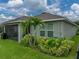 A lush green backyard shows a cozy screened-in lanai and verdant landscaping, ideal for relaxation at 8119 Trimbelle Ter, Parrish, FL 34219