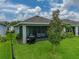 Enjoy the beautiful backyard featuring a screened-in patio, lush lawn, and well-maintained landscaping at 8119 Trimbelle Ter, Parrish, FL 34219