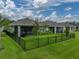 An expansive backyard offers a lush lawn and a secure fence, perfect for Gathering activities and relaxation at 8119 Trimbelle Ter, Parrish, FL 34219