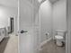 Bright bathroom with a toilet and doorway view to vanity and mirror at 8119 Trimbelle Ter, Parrish, FL 34219