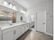 Bright bathroom features double vanity with quartz countertops and large mirrors and cabinet space at 8119 Trimbelle Ter, Parrish, FL 34219