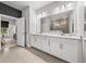 Bright bathroom features double vanity with quartz countertops, under cabinet storage and tile floors at 8119 Trimbelle Ter, Parrish, FL 34219