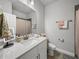 Well-lit bathroom with dual vanity, pink shower curtain, and decorative towels at 8119 Trimbelle Ter, Parrish, FL 34219