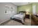 Comfortable bedroom with a window providing natural light, a wooden bed frame and a wooden dresser at 8119 Trimbelle Ter, Parrish, FL 34219