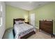 Comfortable bedroom with a wooden bed frame, wooden dresser and an area rug at 8119 Trimbelle Ter, Parrish, FL 34219
