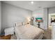 Cozy bedroom showcasing neutral walls, plush bedding, and a mounted television for entertainment at 8119 Trimbelle Ter, Parrish, FL 34219