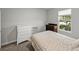 Well-lit bedroom featuring neutral walls, a floral bedspread, and classic wooden dressers at 8119 Trimbelle Ter, Parrish, FL 34219