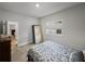 Cozy bedroom with natural light, featuring a wooden dresser, carpet floors and a view of the hall at 8119 Trimbelle Ter, Parrish, FL 34219