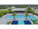 Community pool featuring a sundeck, lounge chairs, covered area, and well maintained greenery at 8119 Trimbelle Ter, Parrish, FL 34219