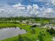 Beautiful community featuring lush landscaping, serene pond, and picturesque surroundings on a sunny day at 8119 Trimbelle Ter, Parrish, FL 34219