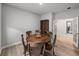 Dining room with wood table and chairs, with view to the hallway and kitchen at 8119 Trimbelle Ter, Parrish, FL 34219