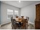 Dining room features hard wood floors, a wooden table, and lots of natural light at 8119 Trimbelle Ter, Parrish, FL 34219