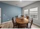 Dining room features a round wood table with chairs and blue accent wall at 8119 Trimbelle Ter, Parrish, FL 34219
