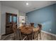 Dining room features a round wood table, china cabinet, with view to the kitchen at 8119 Trimbelle Ter, Parrish, FL 34219