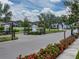 Gated community entrance with manicured landscaping and neighborhood homes at 8119 Trimbelle Ter, Parrish, FL 34219