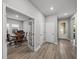 Bright hallway with wood floors, white doors, and a view to the dining room at 8119 Trimbelle Ter, Parrish, FL 34219