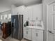 Modern kitchen featuring white cabinets, stainless steel appliances, and quartz countertops at 8119 Trimbelle Ter, Parrish, FL 34219