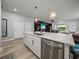 Kitchen island featuring quartz countertops, stainless steel appliances, and a sink with a modern faucet at 8119 Trimbelle Ter, Parrish, FL 34219