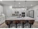 Kitchen island with seating, quartz countertops, stainless steel appliances, and pendant lighting at 8119 Trimbelle Ter, Parrish, FL 34219