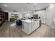 Open concept kitchen with island, granite countertops, and stainless steel appliances at 8119 Trimbelle Ter, Parrish, FL 34219