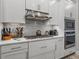 Bright kitchen featuring white cabinets, stainless steel appliances, quartz countertops, and gas stovetop at 8119 Trimbelle Ter, Parrish, FL 34219