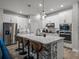 Kitchen island with seating, quartz countertops, stainless steel appliances, and pendant lighting at 8119 Trimbelle Ter, Parrish, FL 34219