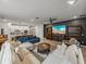 Spacious living room with large TV, built-in shelving, and a sectional sofa for comfortable seating at 8119 Trimbelle Ter, Parrish, FL 34219