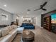 Open-concept living room showing a sectional sofa, round coffee table, and a view of the kitchen at 8119 Trimbelle Ter, Parrish, FL 34219