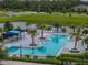 Aerial shot of the pool showing mature tropical landscaping, lounge chairs, and shade at 8119 Trimbelle Ter, Parrish, FL 34219