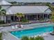 Community pool features a covered seating area, lounge chairs, and palm trees around the pool at 8119 Trimbelle Ter, Parrish, FL 34219