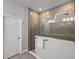 A tiled walk-in shower with glass enclosure featuring a window and stainless steel shower head at 8119 Trimbelle Ter, Parrish, FL 34219