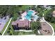 The aerial view showcases a community pool and playground bordered by lush landscaping, offering a serene escape at 828 Terra Vista St, Brandon, FL 33511